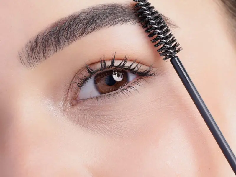 Laminated eyebrow being brushed into shape Beauty by Ana St Albans