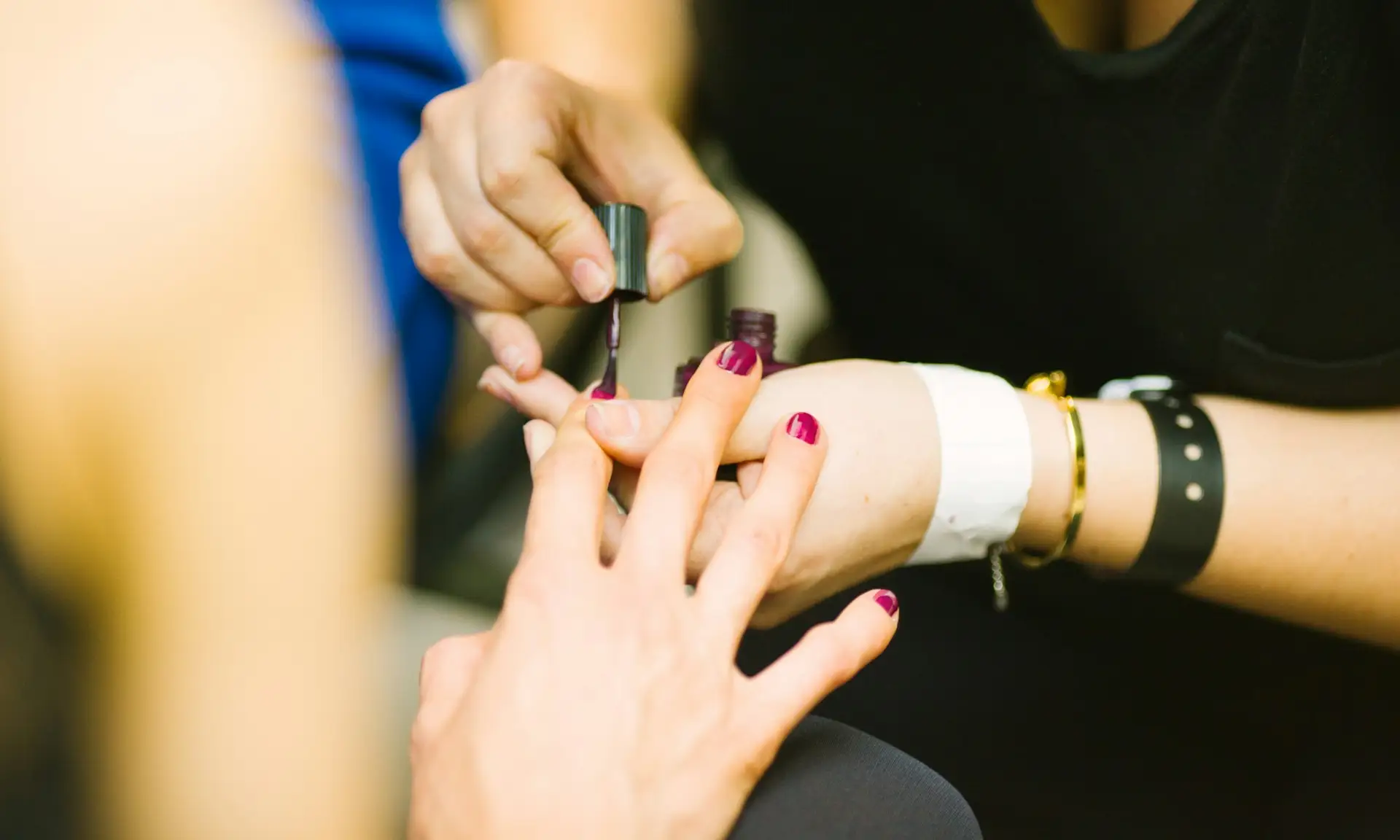 Nail technician painting a client's nails during a manicure Beauty by Ana St Albans