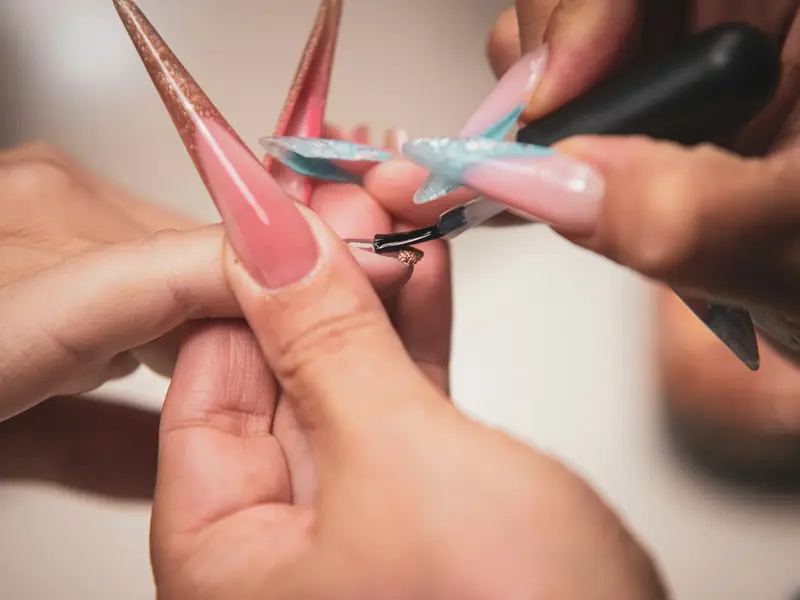 Long almond acrylic nail extensions being shaped Beauty by Ana St Albans